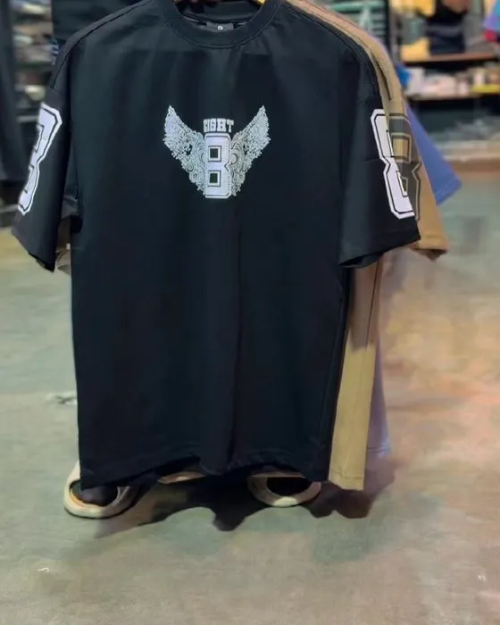 Close-up of the winged eight chest print and sleeve number