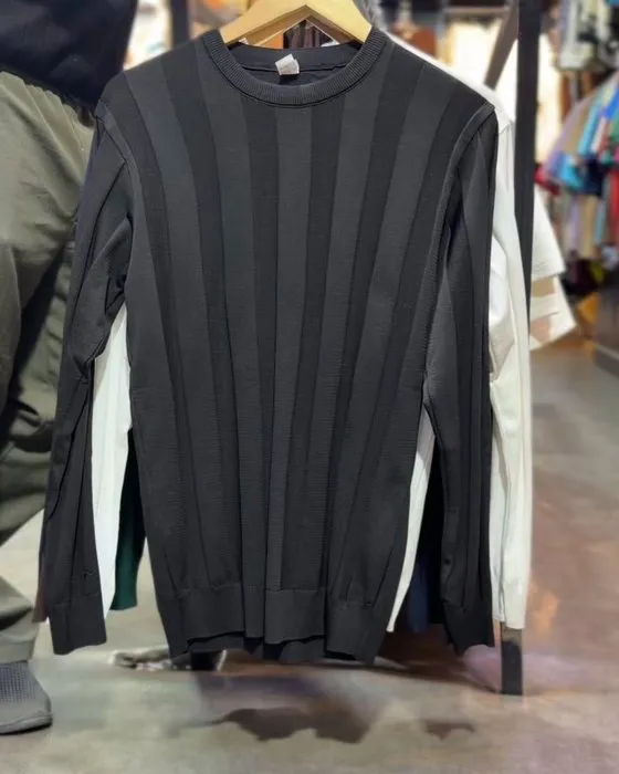 Close-up of the vertical rib texture on the black knit